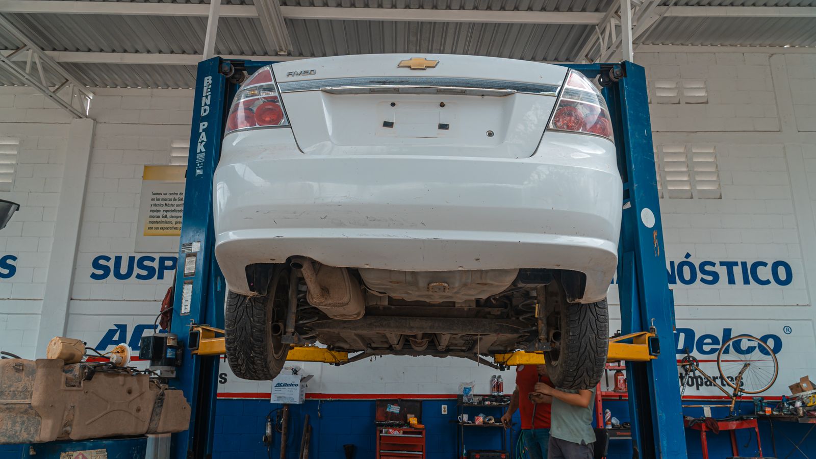 Mechanic servicing a vehicle at an auto repair shop