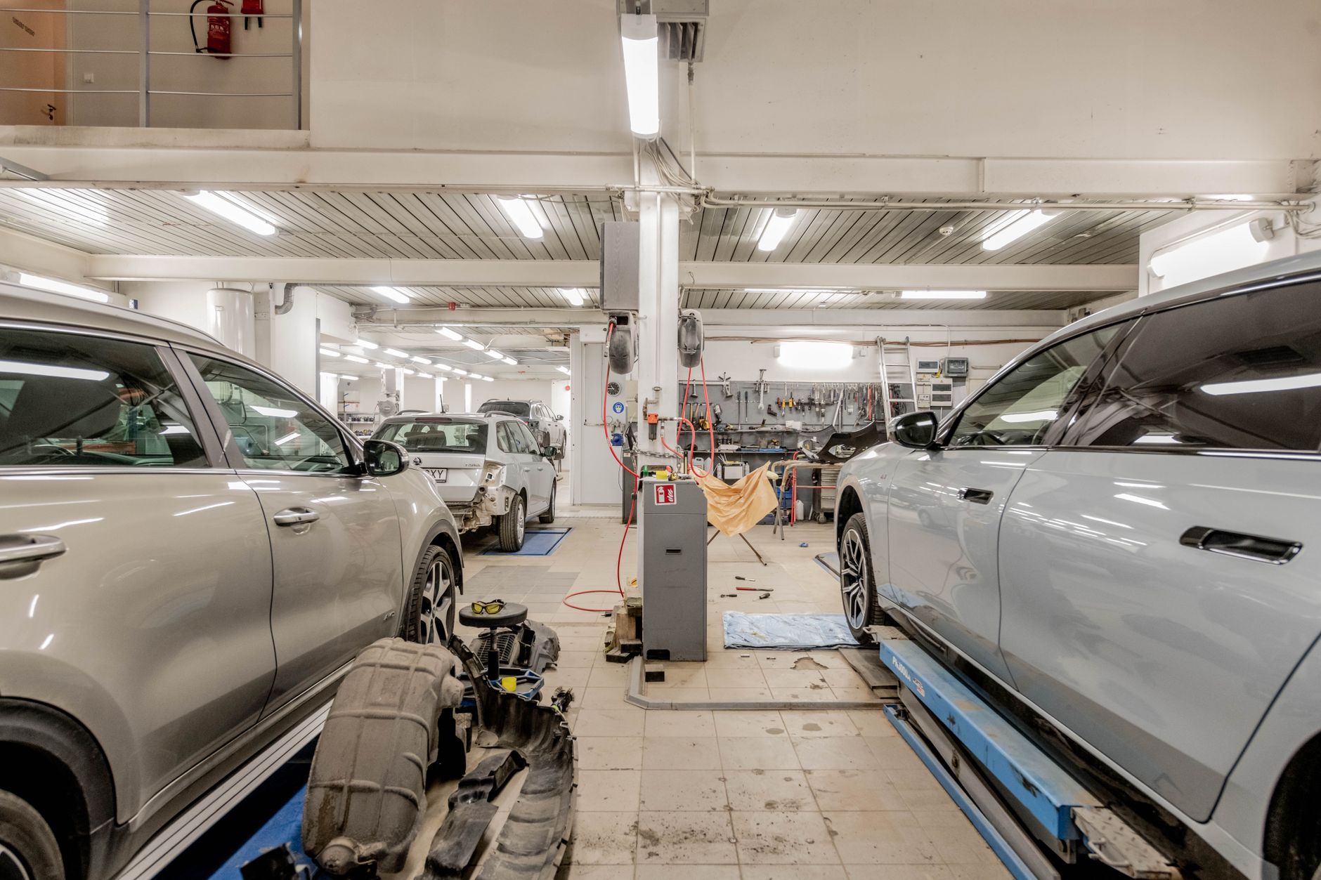 Interior of an automotive repair shop with cars undergoing maintenance